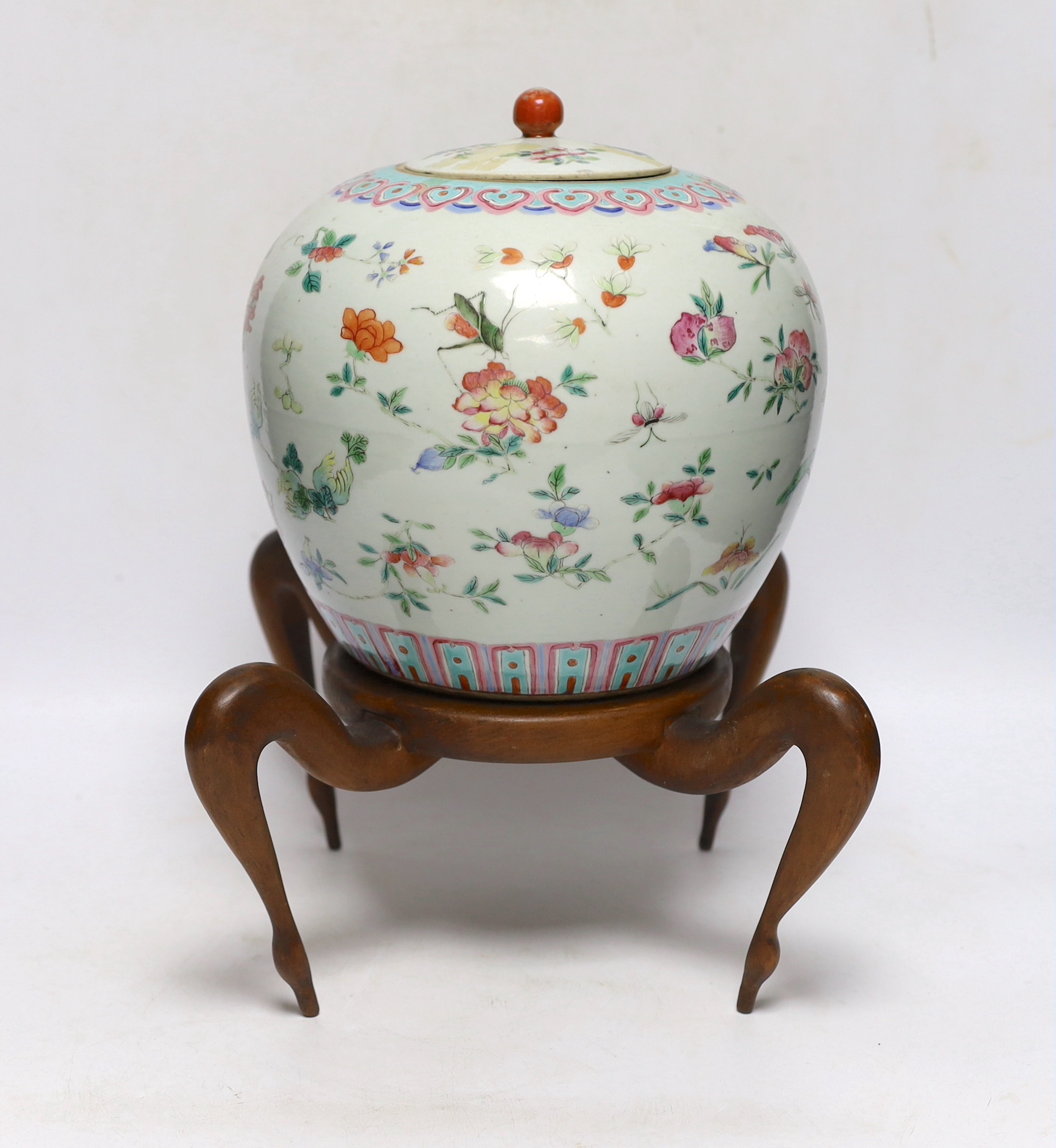 A 19th century Chinese famille verte jar and cover, on associated wooden stand, vase 22cm